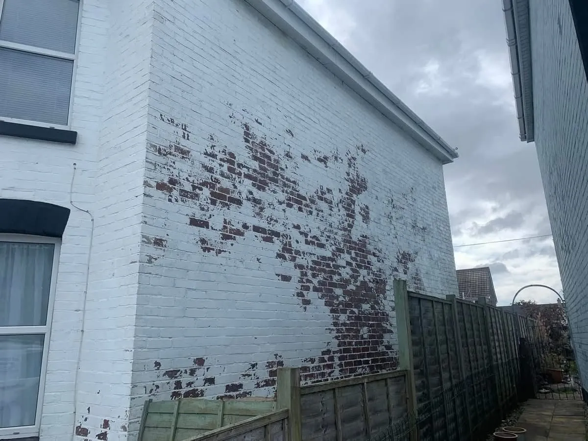 Peeling paint on a brick wall before redecoration in Carn Brea